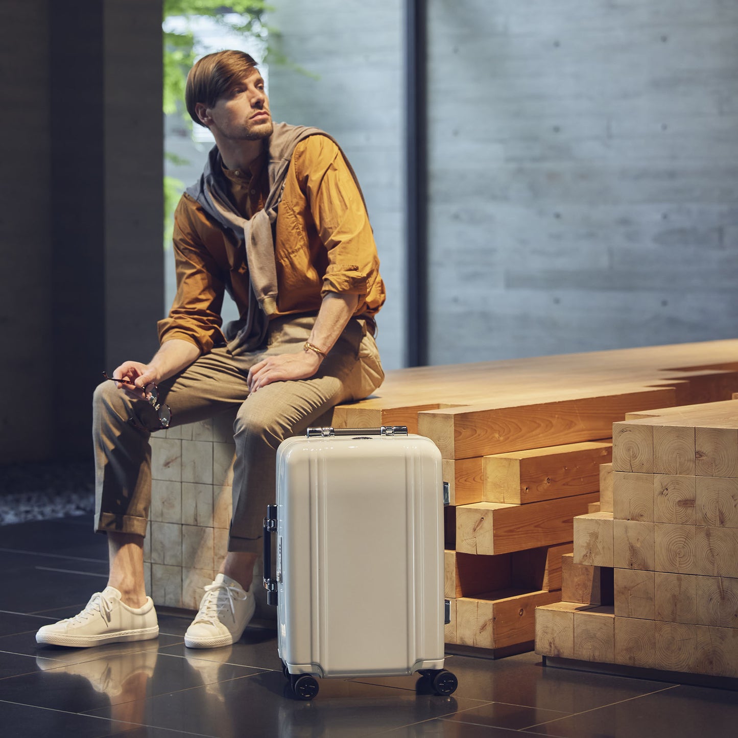BLUE Classic Lightweight 3.0 Carry-on with a man sitting