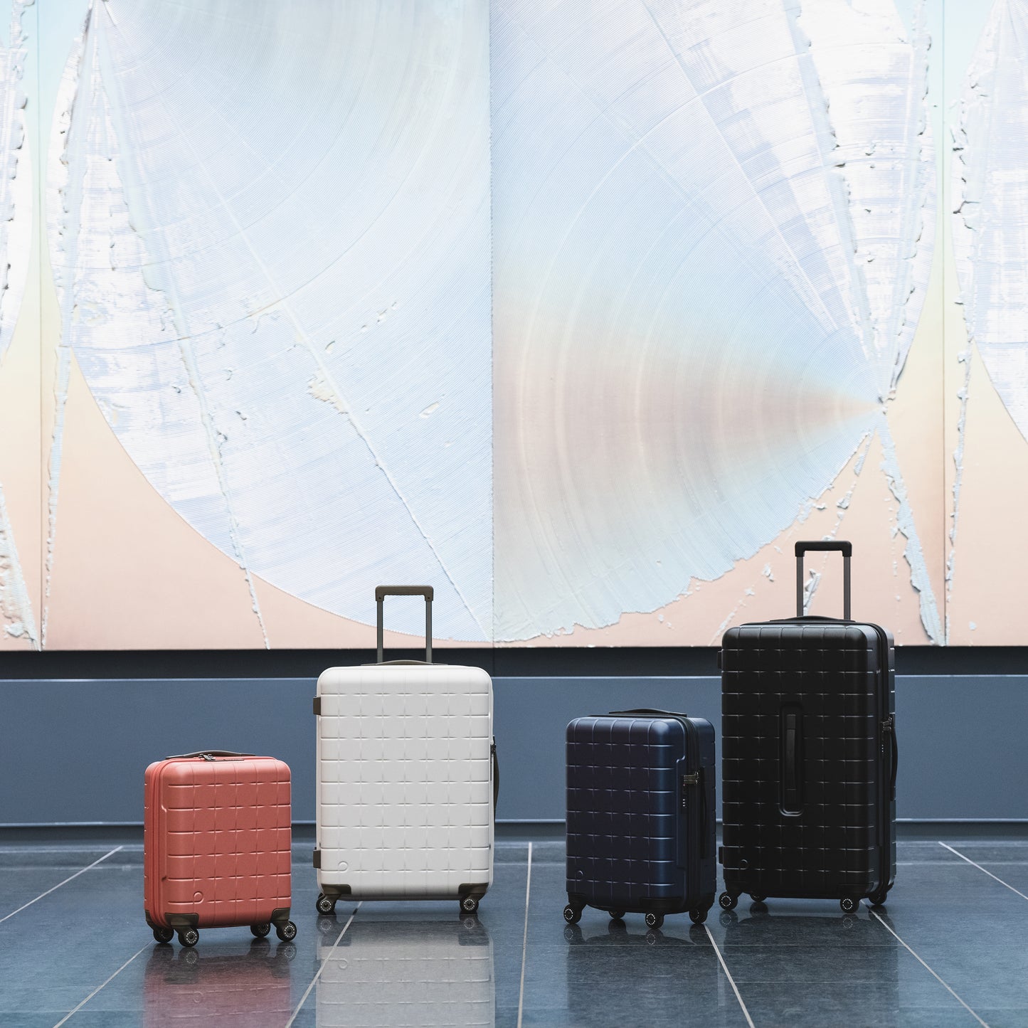 PROTECA 360G4 luggage collection in multiple sizes and colors displayed in modern interior setting